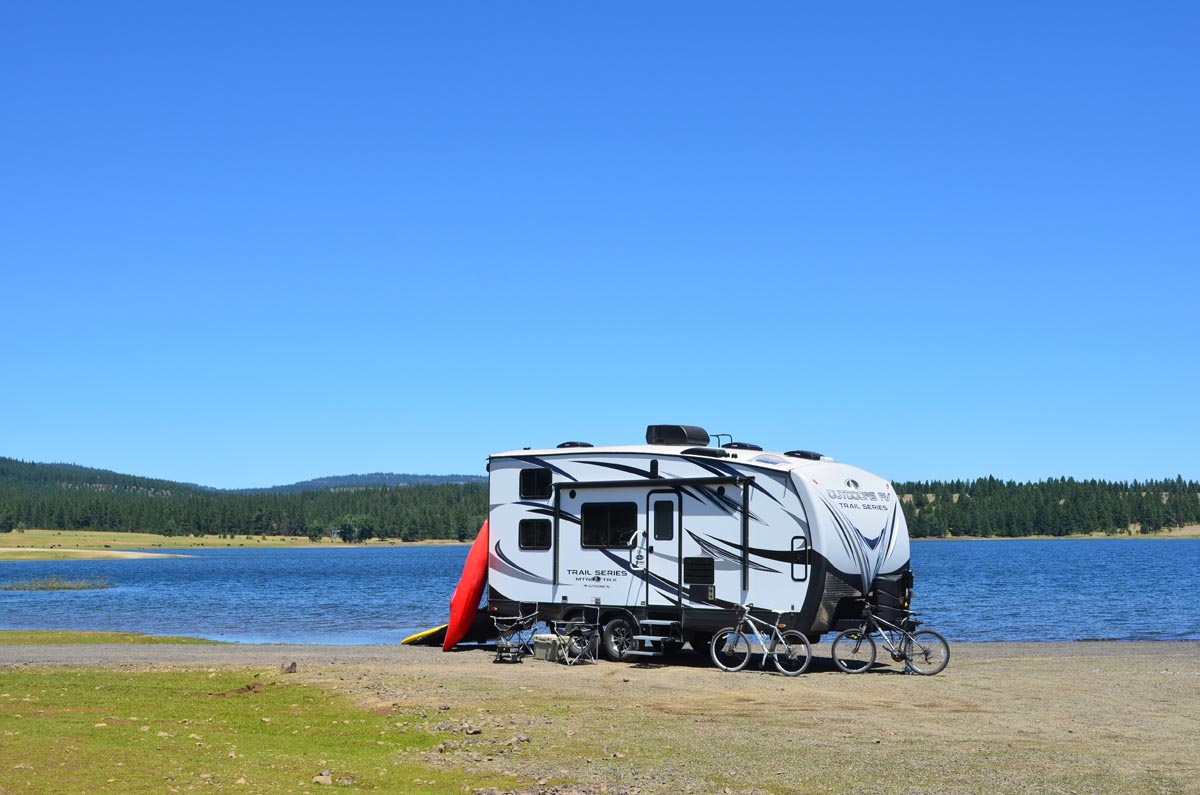 2019 Outdoors RV Trail Series 27TRX parked next to a body of water